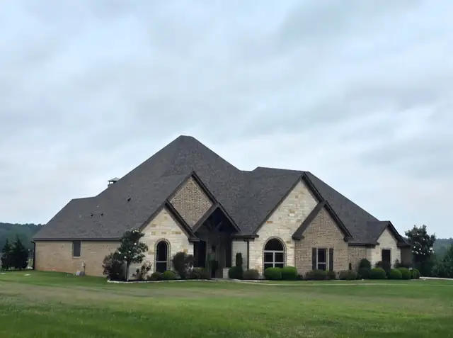 New shingle roof on a stone two-story house